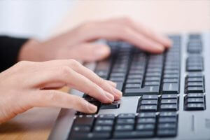 person typing on keyboard