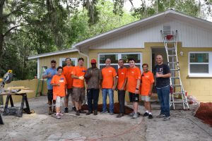 Group photo with Home Depot volunteers, homeowner, and Habitat Lake-Sumter staff
