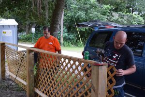 Home Depot volunteer and Habitat Lake-Sumter staff working on lattice
