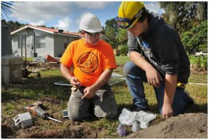 Instructor Dan McCauley helps Leesburg High School Construction Academy student Austin Marshall with plumbing on a project in 2018. [Daily Commercial file]