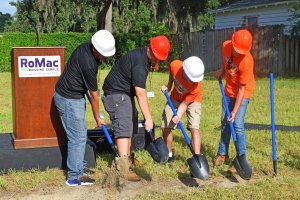 students turning dirt over at ground breaking