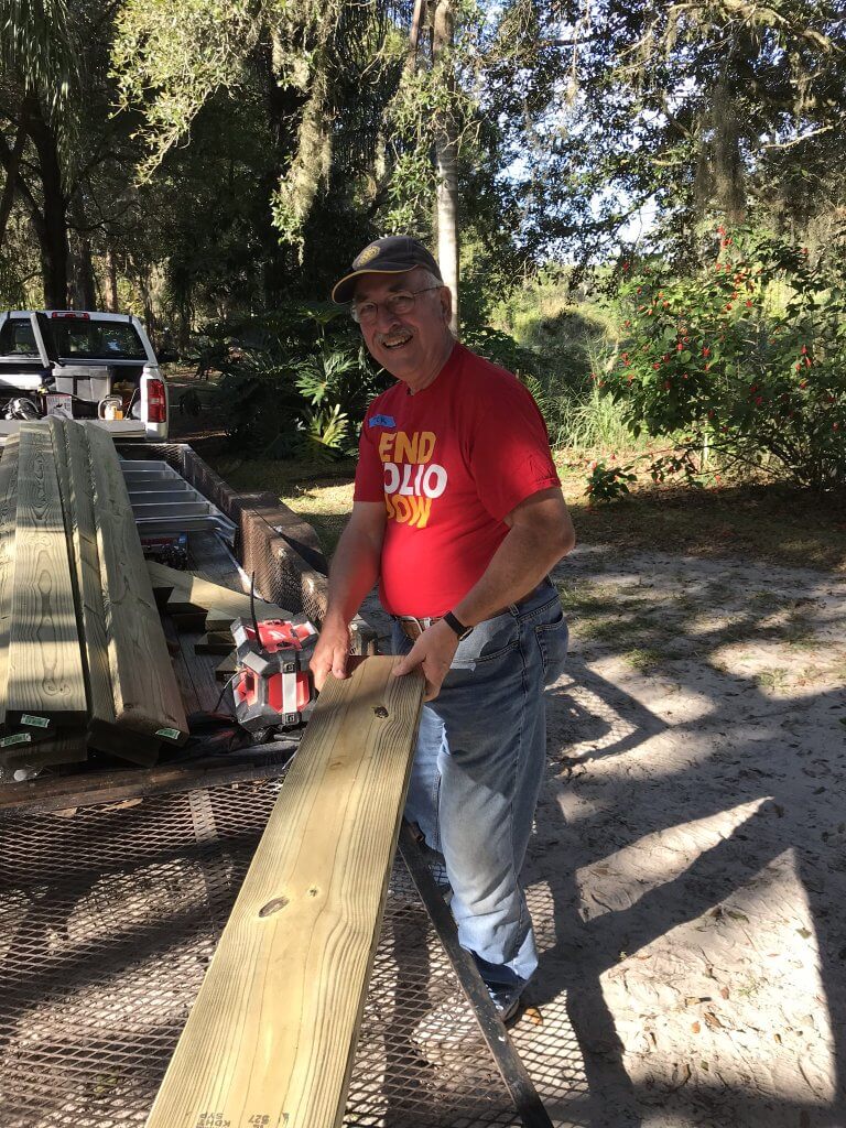 volunteer unloading lumber