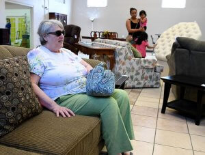 Ann Walls, of Virginia, tries out a couch while shopping at the Habitat for Humanity ReStore in Leesburg on Wednesday. Michael Johnson, Daily Sun
