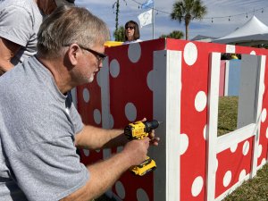 Construction Manager Barry Martin working on a playhouse at our first annual Jingle Build-Off
