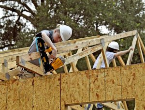 Jakobe Zick, a member of The Villages High School Construction Management Academy, nails a roof truss into place on a home being built for Habitat for Humanity Lake-Sumter in Lady Lake. The organization was named 2020 Non-Profit of the Year by the Lake County Chamber Alliance.