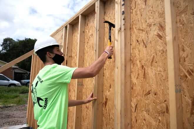 A student from the Leesburg High School Construction Academy works on construction a home for Habitat for Humanity in Leesburg in 2020. Cindy Peterson/Correspondent/File Photo