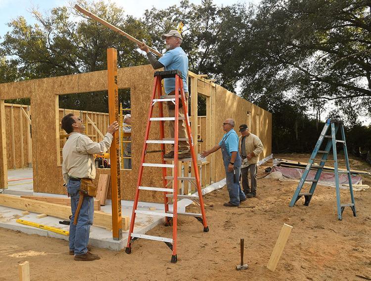 Volunteers with The Villages Habitat for Humanity Club, left to right, Fran Harper, of the Village of Hemingway, Kevin Tucker, of the Village Del Mar, Andy Laskowsky, of the Village Rio Grande, and John Holmes, of the Village of Pine Ridge, help build a home on Skycrest Boulevard in Fruitland Park. George Horsford, Daily Sun